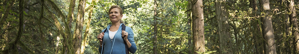 Woman walking through forest - Orthopedic-Services
